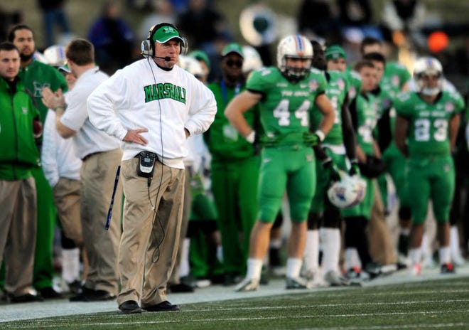 FILE - In this Dec. 27, 2013, file photo, Marshall's head coach Doc Holliday watches from the sideline in the first half of the Military Bowl against Marshall in Annapolis, Md. Now that Chris Petersen has left Boise State for Washington, college football needs another coach from outside the so-called Big 5 conferences that will have his name come up for almost every big job. (AP Photo/Gail Burton, File)