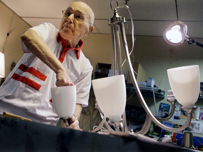 Lighting repair specialist Herman "Hy" Goldman, 101, refurbishes a light fixture in his workshop at Capitol Lighting where he has worked for 73 years, Monday, Aug. 18, 2014, in East Hanover, N.J.