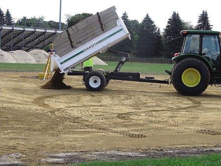 Steve Craig photo
The remaking of both the junior varsity and varsity softball diamond infields is underway at Winnacunnet High School. On Monday, the JV field was getting its coating of clay infield mix.