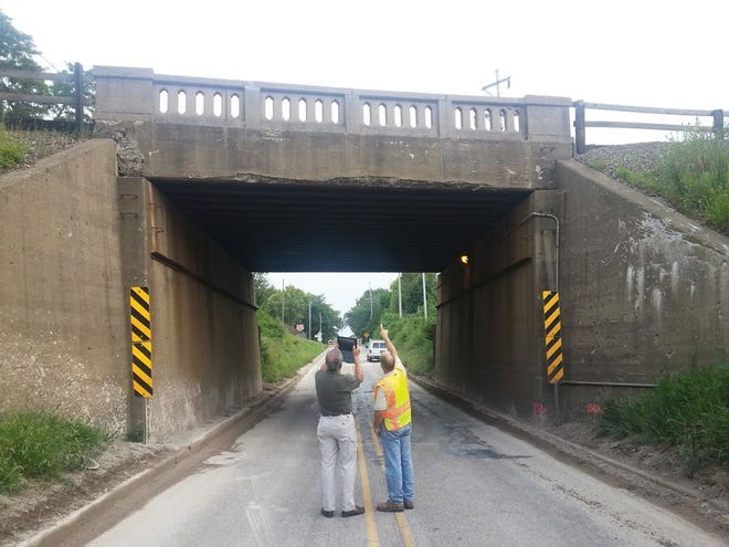 Mayor Doug Crew uses a tablet to capture images of one of the tunnels of the viaduct on the north side of town. The area was closed for two weekends in a row so that road crews could resurface the roadway as it had become rough from potholes and patches.