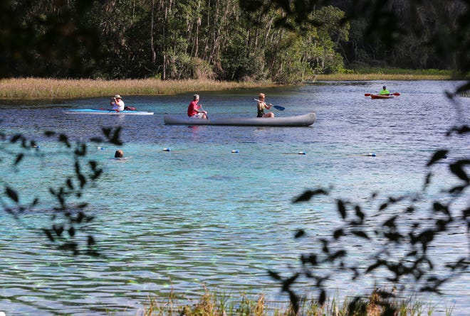 Kayakers and canoeists paddle in the spring-like weather near the main spring at Rainbow Springs State Park just north of Dunnellon, Fla. on Tuesday, Feb. 4, 2014.