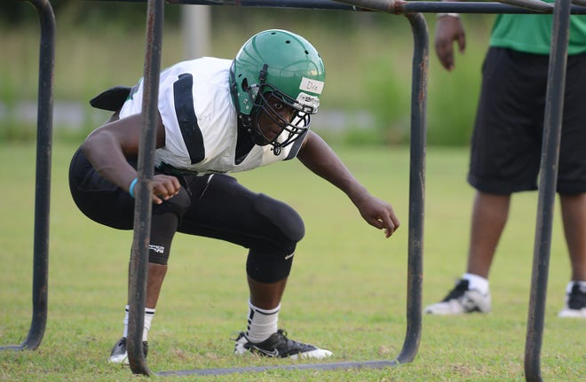 A member of the North Lenoir's football team shows off his skills during offensive line drills during a practice earlier this month