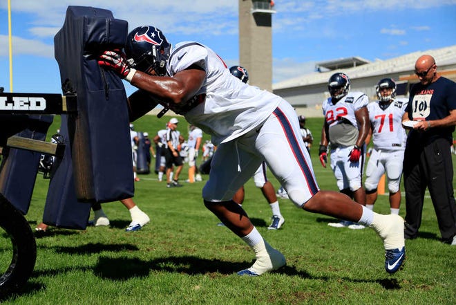 Houston Texans defensive end Keith Browner hits the sled during a joint practice between the Denver Broncos and the Houston Texans on Wednesday, Aug. 20, 2014, in Englewood, Colo. (AP Photo/Jack Dempsey)