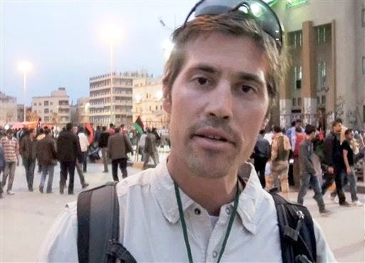 FILE - This undated file still image from video released April 7, 2011, by GlobalPost, shows James Foley of Rochester, N.H., a freelance contributor for GlobalPost, in Benghazi, Libya. In a horrifying act of revenge for U.S. airstrikes in northern Iraq, militants with the Islamic State extremist group have beheaded Foley — and are threatening to kill another hostage, U.S. officials say.