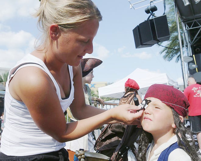 Carrie Pate puts an eyepatch on her 4-year-old son, Gavin, while preparing for a pirate costume contest at Pier Park in Panama City Beach at the 2013. This year the Grand Lagoon area will host its own event for the annual festival, complete with a pirate invasion and fireworks show.