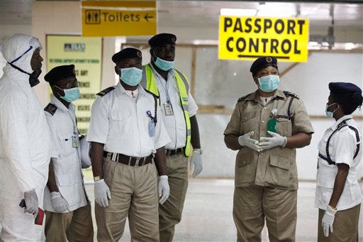 In this Monday Aug. 4, 2014 file photo, a Nigerian port health officials wait to screen passengers at the arrivals hall of Murtala Muhammed International Airport in Lagos, Nigeria. Two new cases of Ebola have emerged in Nigeria and, in an alarming development, they are outside the group of caregivers who treated an airline passenger who arrived with Ebola and died, Health Minister Onyebuchi Chukwu said Friday, Aug. 22, 2014. (AP Photo/Sunday Alamba, File)