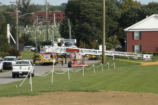 A Campbellsville Fire Department truck with the ladder extended remained at the scene where two firefighters were injured during an ice bucket challenge during a fundraiser for ALS on Thursday, Aug. 21, 2014, in Campbellsville, Ky. Officials say the ladder got too close to a power line and electricity traveled to the ladder, electrocuting the firefighters. (AP Photo/Dylan Lovan)