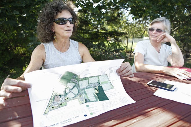 Roby Faria, left, and her neighbor Kathy Davis are leading a group of abutters who live near a proposed baseball-lacrosse complex in Middletown off Mitchell’s Lane. The neighbors say the proposed development is far bigger than what was originally planned there and stretches the definition of open space.