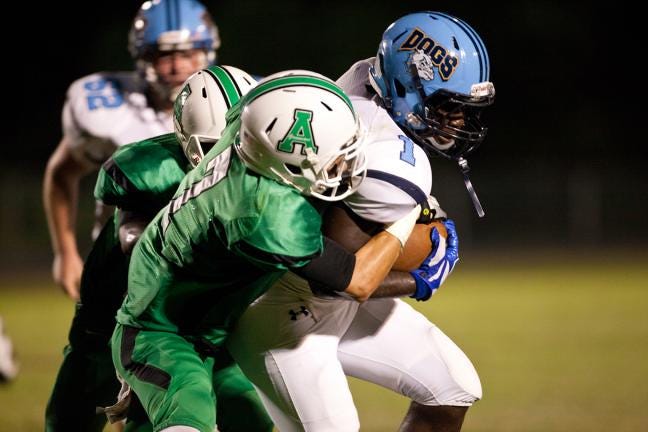 Ashbrook’s Devin Gonter tackles Burns running back Mike Tate during Friday night’s game in Gastonia.