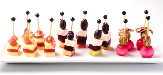 Tapas and small bites make a refreshing, relaxing summer meal, such as the above "Pintxos", or skewered bites with a mix of ingredients such as olives, cheeses, and meats.