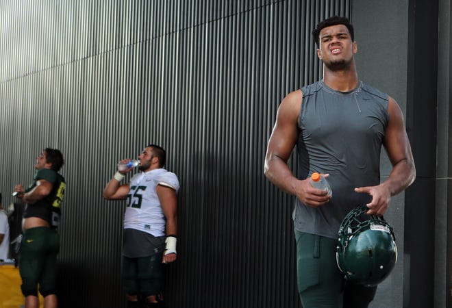 Oregon’s Arik Armstead (right) leaves practice earlier this summer. The junior defensive end with classmates DeForest Buckner and Alex Balducci are expected to make up the Ducks’ starting defensive line this season. (Chris Pietsch/The Register-Guard)