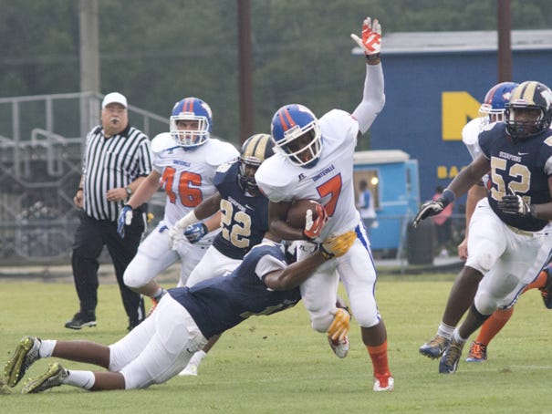 Whiteville's Marcus Coleman tries to escape a tackle Saturday during the Wolfpack's win against North Brunswick in a continuation of the Friday season opener postponed by rain.