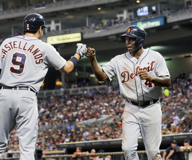 Detroit Tigers Torii Hunter, right, celebrates with Nick Castellanos (9) after scoring on a J.D. Martinez single against the Minnesota Twins during the third inning of a baseball game Saturday, Aug. 23, 2014 in Minneapolis. (AP Photo/Craig Lassig)