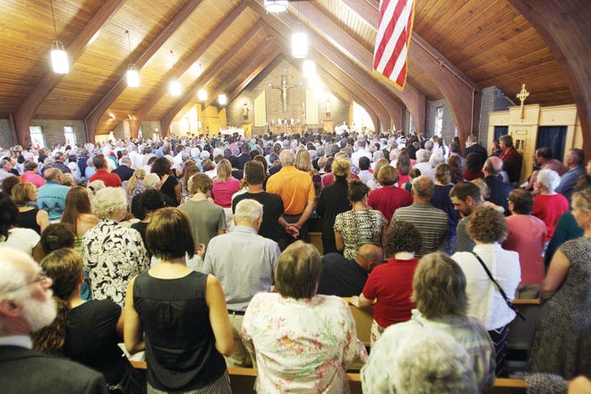 Mourners pack Our Lady of the Holy Rosary Catholic church Sunday during a special Mass for slain journalist James Foley in his hometown of Rochester.