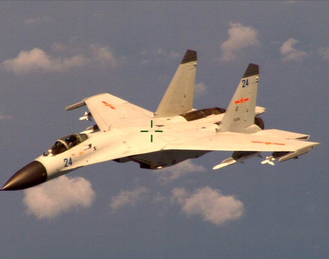 This handout photo provided by the Office of the Defense Secretary (OSD), taken Aug. 19, 2014, shows a Chinese fighter jet that the Obama administration said Friday conducted a "dangerous intercept" of a U.S. Navy surveillance and reconnaissance aircraft off the coast of China in international airspace.