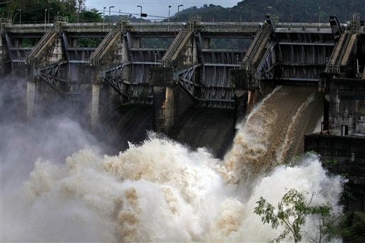 Water rushes through an open bay at the Carraizo Dam to release water left by tropical storm Cristobal in Trujillo Alto, Puerto Rico, Saturday.