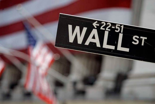 FILE - In this May 11, 2007, file photo, a Wall Street sign is mounted near the flag-draped facade of the New York Stock Exchange. Global stock markets were mostly higher Monday, Aug. 25, 2014, after top central bankers in Europe and Japan said support for their economies would continue and additional help is possible. Investors are hoping the stock market will pick up steam this week. (AP Photo/Richard Drew, File)