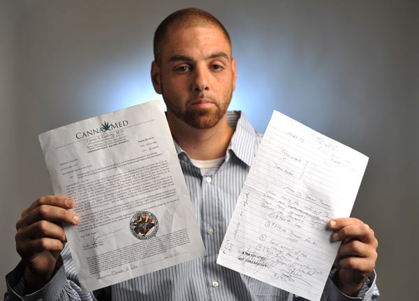 HYANNIS - Derick Eaton with a copy of his medical marijuana certificate, left, and a judge's order giving him back confiscated money and marijuana.