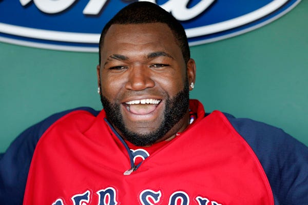 Boston Red Sox's David Ortiz laughs in the dug out before a baseball game against the Seattle Mariners in Boston, Friday, Aug. 22, 2014.