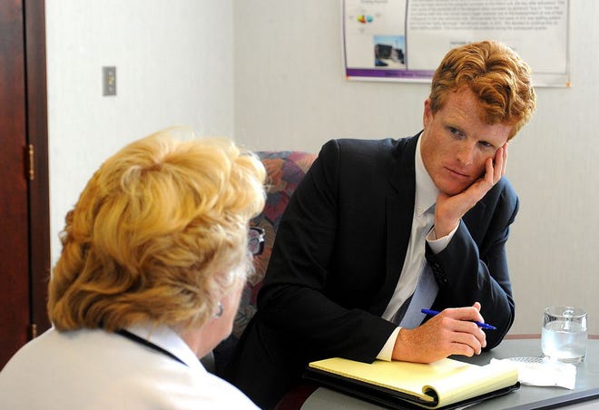 U.S. Rep. Joseph Kennedy III listens to Stanley Street Treatment and Resources CEO Nancy Paull talk about the agency's work and its needs during a visit Monday.