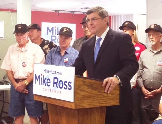 John Lyon • Arkansas News Bureau / Democratic candidate for governor Mike Ross discusses his plan to aid veterans during a news conference in Little Rock on Monday, Aug. 25, 2014, as members of the group Veterans for Ross look on.