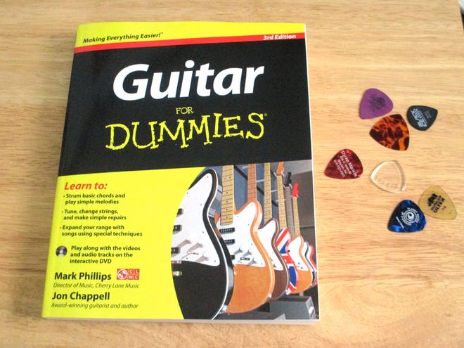 A guitar lesson book, some picks and, of course, a guitar are a good starting point to learn to play.