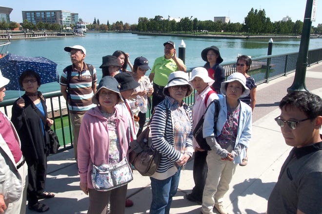 Representatives from Stockton's sister city, Shizuoka, Japan, visit the downtown marina on Tuesday. CALIXTRO ROMIAS/The Record