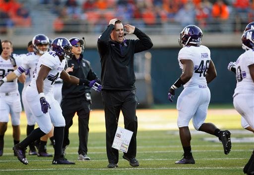 FILE - In this Nov. 30, 2013, file photo, Northwestern head coach Pat Fitzgerald yells at his team during an NCAA college football game against Illinois in Champaign, Ill. The Wildcats are coming off a disappointing 5-7 season and already hit hard by injuries and a key defection ahead of the Saturday, Aug. 30, 2014, opener at home against Cal. On top of that, they spent the offseason at ground zero in the debate over whether college players should have the right to unionize. (AP Photo/Jeff Haynes, File)