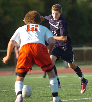 Swampscott's Ray Rosa goes up against a Beverly player during an Oct. 3, 2013, game at Beverly High school. Wicked Local Staff Photo / Nicole Goodhue Boyd