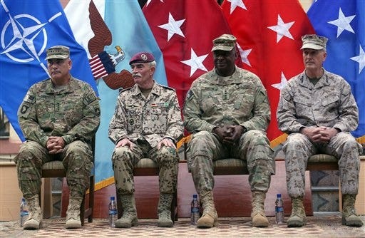 Outgoing commander of ISAF, U.S. Gen. Joseph Dunford, first right, and incoming U.S. Army Commander for International Security Assistance Forces (ISAF), Gen. John F. Campbell, first left, sit after the change of command ceremony at the ISAF Headquarters in Kabul, Afghanistan, Tuesday, Aug. 26, 2014. ISAF is a NATO-led security mission in Afghanistan that was established by the United Nations Security Council in 2001. It will end its mission at the end of 2014. (AP Photo/Massoud Hossaini)