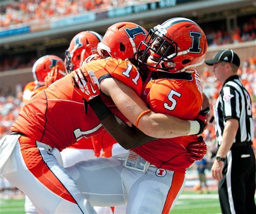 Illinois tight end Matt LaCosse (11) hugs running back Donovonn Young (5) after Young's touchdown during the second quarter against the Southern Illinois in an NCAA college football game at Memorial Stadium in Champaign, Ill., on Saturday, Aug. 31, 2013. (AP Photo/The News-Gazette, Bradley Leeb)