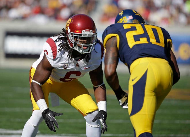 FILE - In this Nov. 9, 2013, file photo, Southern California cornerback Josh Shaw, left, lines up against California defensive back Isaac Lapite during the first quarter of an NCAA college football game in Berkeley, Calif. Shaw injured both ankles after leaping from a second-story balcony to save his 7-year-old nephew, Carter, from drowning in a pool. Shaw was named a team captain on Saturday, Aug. 23, 2014, and later that night was attending a family function at a cousin's apartment in his hometown of Palmdale when he saw his nephew, who can't swim, struggling in the pool. (AP Photo/Eric Risberg, File)