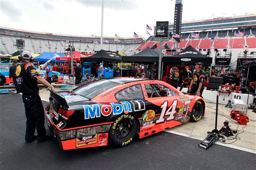 Crew members work on the car of Tony Stewart's car driven by Jeff Burton during practice for the Irwin Tools Night Race NASCAR Sprint Cup Series auto race at Bristol Motor Speedway on Friday in Bristol, Tenn. Stewart will return to racing this week after a fatal wreck took the life of a young Sprint car driver in a non-NASCAR event in New York.