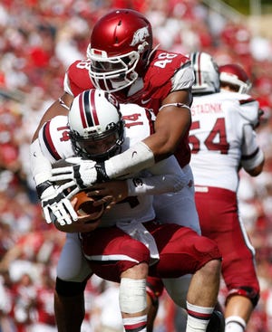 Marc F. Henning * Arkansas News Bureau  Arkansas defensive tackle Deatrich Wise Jr. sacks South Carolina quarterback Connor Shaw for a big loss during the second quarter of the Razorbacks' game Saturday, Oct. 12, 2013, against the Gamecocks at Reynolds Razorback Stadium in Fayetteville.