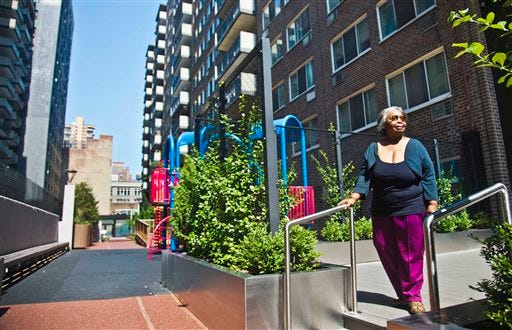 In this Aug. 5, 2014 photo, Jean Green Dorsey walks outside the building on New York City’s Upper West Side where she has lived since 1972. Dorsey has a rent stabilized unit in a building that also houses market rate residents. As a rent stabilized tenant, Dorsey is not allowed to use the new gym that market rate residents use for free, even if she paid for the privilege.
