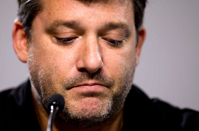 NASCAR auto racing driver Tony Stewart reads a statement during a news conference at Atlanta Motor Speedway in Hampton, Ga., Friday, Aug. 29, 2014. Stewart says the death of Kevin Ward Jr. will "affect my life forever" as he returned to the track for the first time since his car struck and killed the fellow driver during a sprint-car race in New York. (AP Photo/John Bazemore)