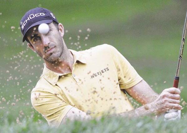 Geoff Ogilvy hits out of a bunker on the fourth hole during the final round of the BMW Championship golf tournament Sunday, Sept. 18, 2011, in Lemont, Ill.
