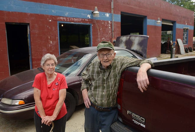 Raymond L. Brown, Sr., 83, with his wife, Mary Brown, stand outside Brown's General Auto Repair in Sterling. He is closing the business which has been open since 1938. John Shishmanian/ NorwichBulletin.com