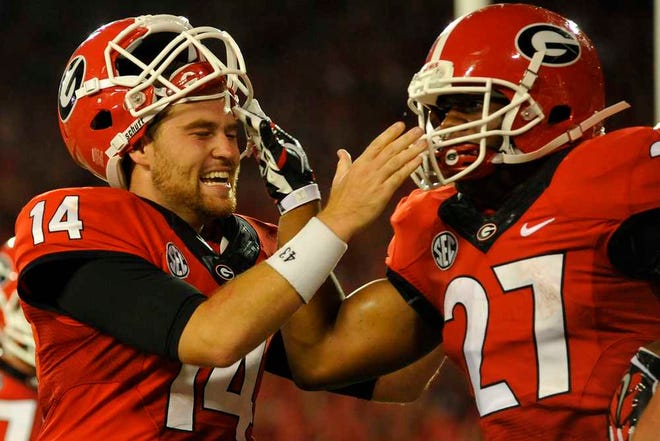 Georgia quarterback Hutson Mason (14) and Georgia running back Nick Chubb (27) celebrate after a touchdown during the second half of the NCAA college football game between Georgia and Clemson on Saturday, August 30, 2014, in Athens, Ga. (AJ Reynold/Staff, @ajreynoldsphoto)