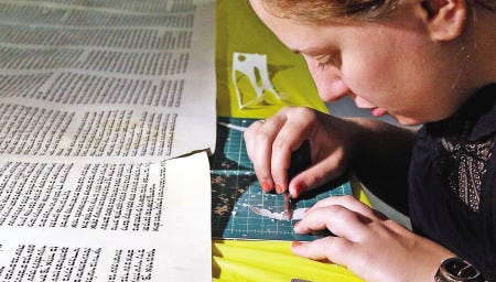 Rachel Salston, 24, of Los Angeles, repairs a damaged Torah used by the Jewish Academy of Orlando in Maitland, Fla.