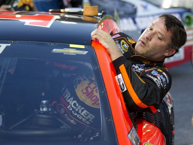 Sprint Cup Series driver Tony Stewart (14) climbs out of his car after qualifying for Sunday's Oral B USA 500 NASCAR race at Atlanta Motor Speedway on Friday in Hampton, Ga.