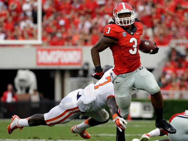 Georgia's Todd Gurley runs past the reach of Clemson's Tony Steward on Saturday in Athens, Ga. Gurley rushed for 198 yards and three touchdowns and also took a kickoff 100 yards for a score during the Bulldogs' 45-21 victory.