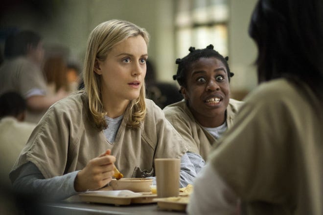 Taylor Schilling, left, and Uzo Aduba in a scene from "Orange Is the New Black," a Netflix show that is the second most-pirated in the world.