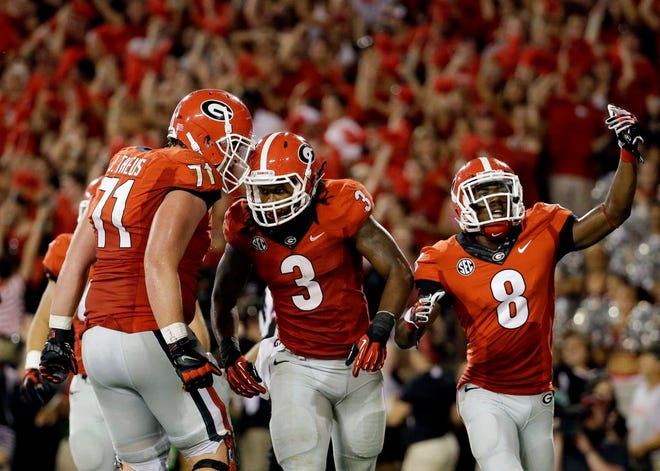 Georgia running back Todd Gurley (3) celebrates with teammates after scoring in the second half of an NCAA college football game against Clemson, Saturday, Aug. 30, 2014, in Athens, Ga.