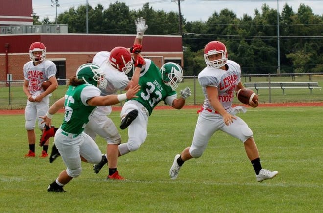 Lenape lineman Pat Byrne (77) springs quarterback Jimmy Kennedy into the open field during a preseason scrimmage.