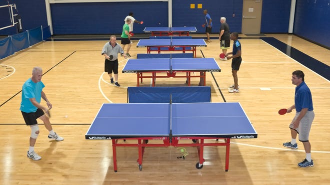 Members of the Davidson County Parks and Recreation Department's Table Tennis Club compete in the gymnasium at the department on West Center Street Extension on Thursday night.
