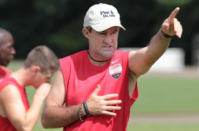(Photo by Mike Hensdill) Belmont Abbey men's soccer coach John Keating directs his team during a recent practice drill