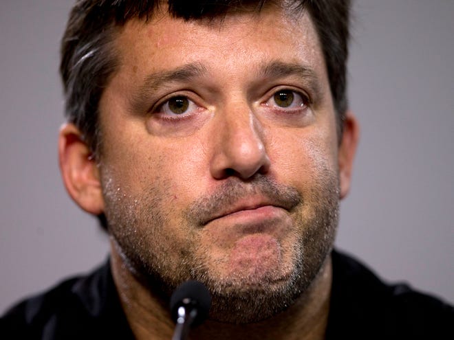 Tony Stewart reads a statement during a news conference on Friday at Atlanta Motor Speedway in Hampton, Ga.