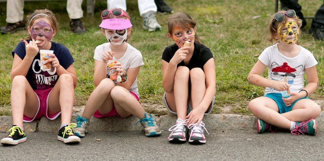 Caitlyn Burke, 8; Emma Gasco, 8; Hannah Burke, 10; and Samantha Gasco, 6, eat ice cream at Charlton Old Home Day Monday.