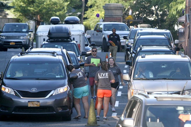 First-year students and families arrive Saturday at the College of the Holy Cross in Worcester.